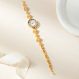 Reloj dorado de acero floral